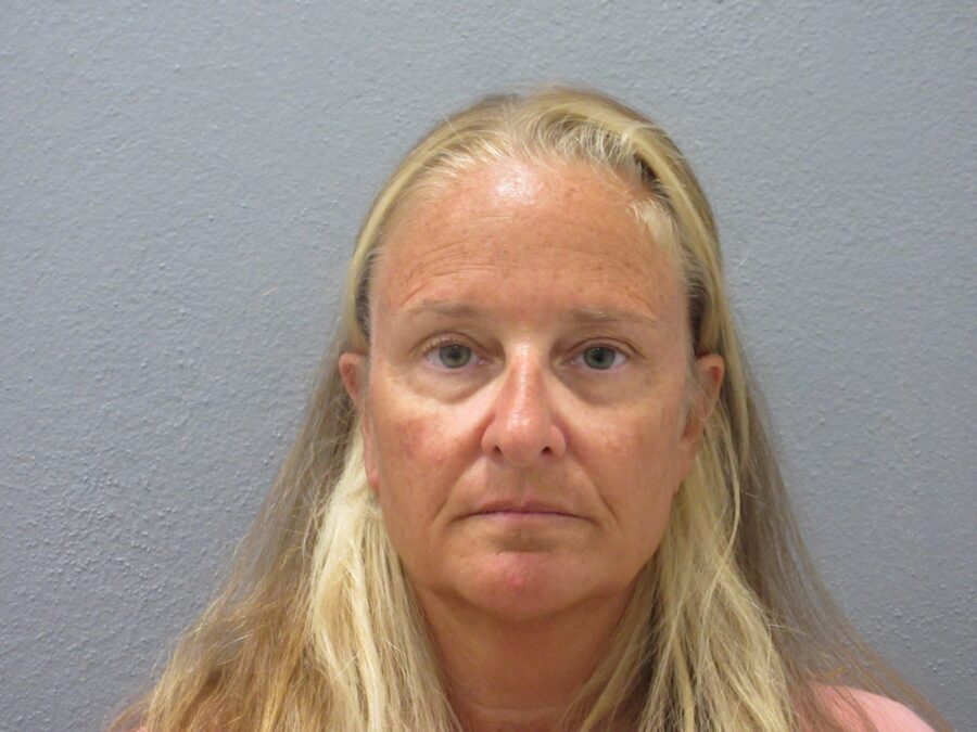 a woman with long blonde hair is looking at the camera