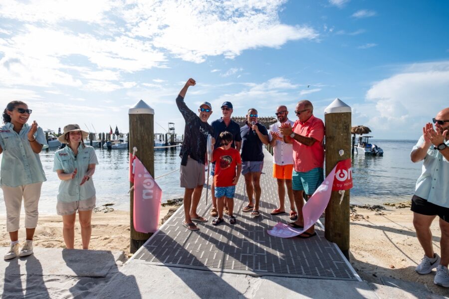 a group of people standing on top of a pier