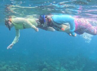 a man and a woman swimming in the ocean