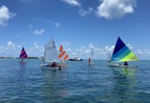 a group of sailboats floating on top of a body of water