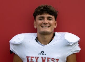 a man in a football uniform poses for a picture