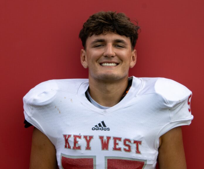 a man in a football uniform poses for a picture