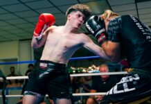 a couple of men standing next to each other in a boxing ring