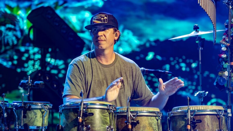 a man is playing drums on stage