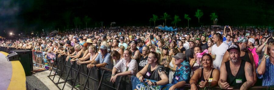 a large group of people sitting in front of a stage