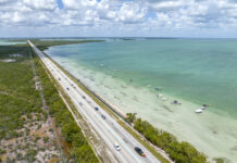 an aerial view of a highway near the ocean