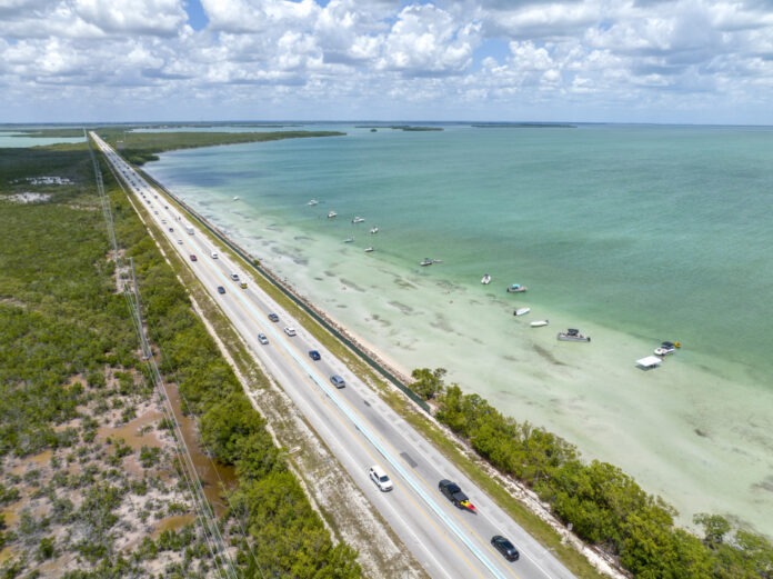 an aerial view of a highway near the ocean