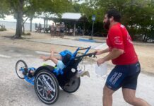 a man pushing a child in a wheelchair