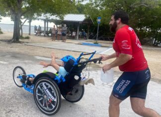 a man pushing a child in a wheelchair