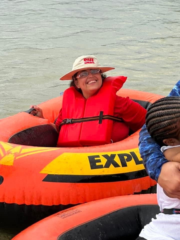 a group of people in inflatable rafts on the water