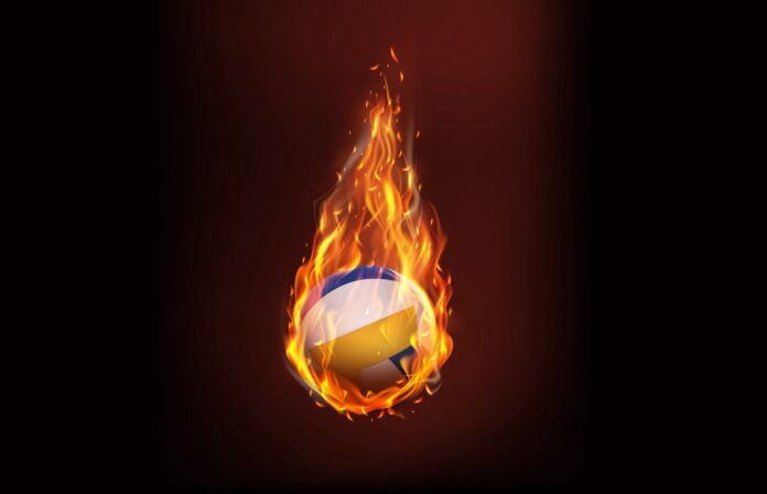 a volleyball ball on fire with a dark background
