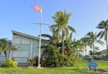 a blue building with a flag on top of it