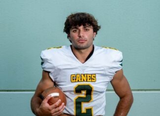 a man in a football uniform holding a football