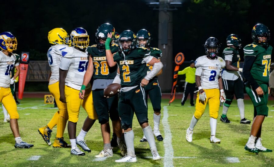 a group of football players standing on top of a field