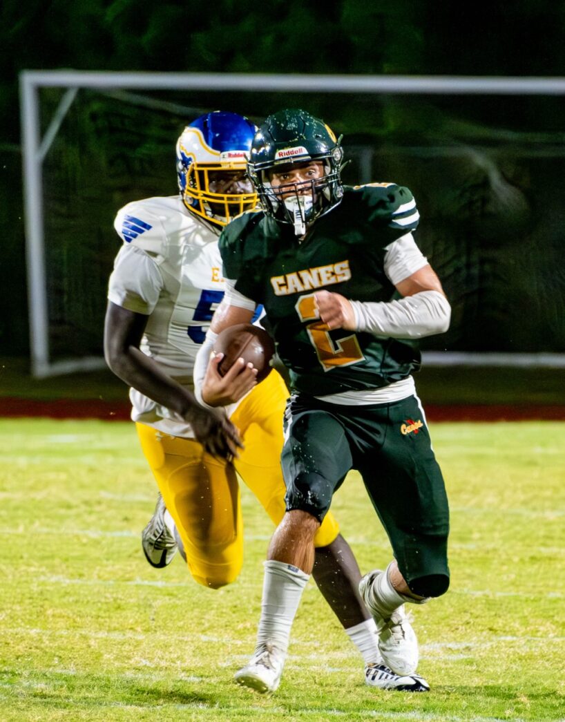 a football player running with the ball during a game