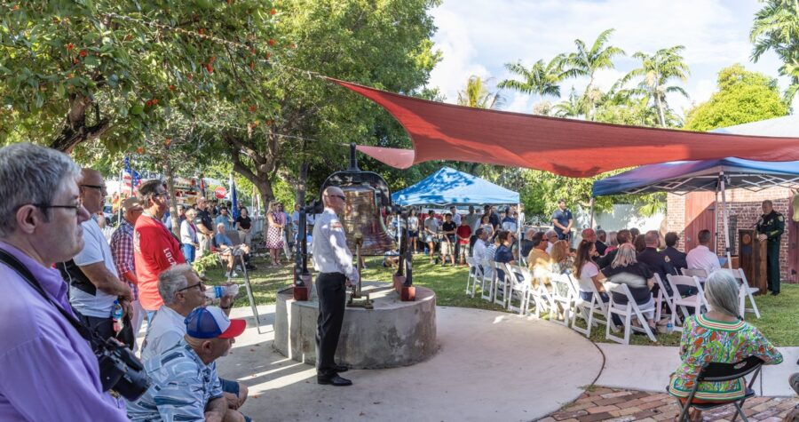 a group of people sitting in chairs under a tent