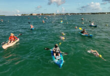 a group of people in kayaks paddling in the water