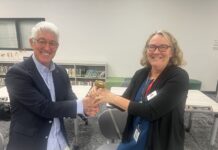 a man and a woman shaking hands in an office