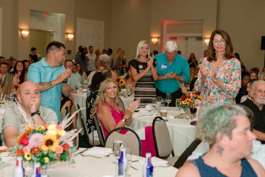 a group of people sitting at tables in a room