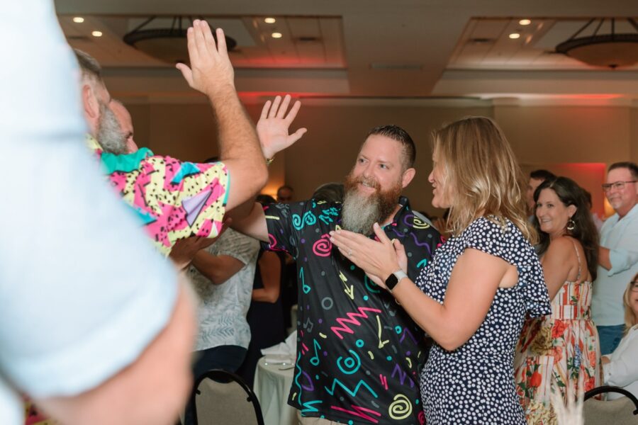 a group of people standing around each other at a party