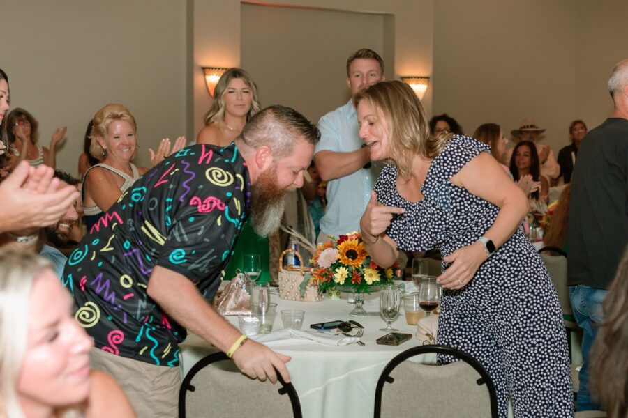 a group of people standing around a table