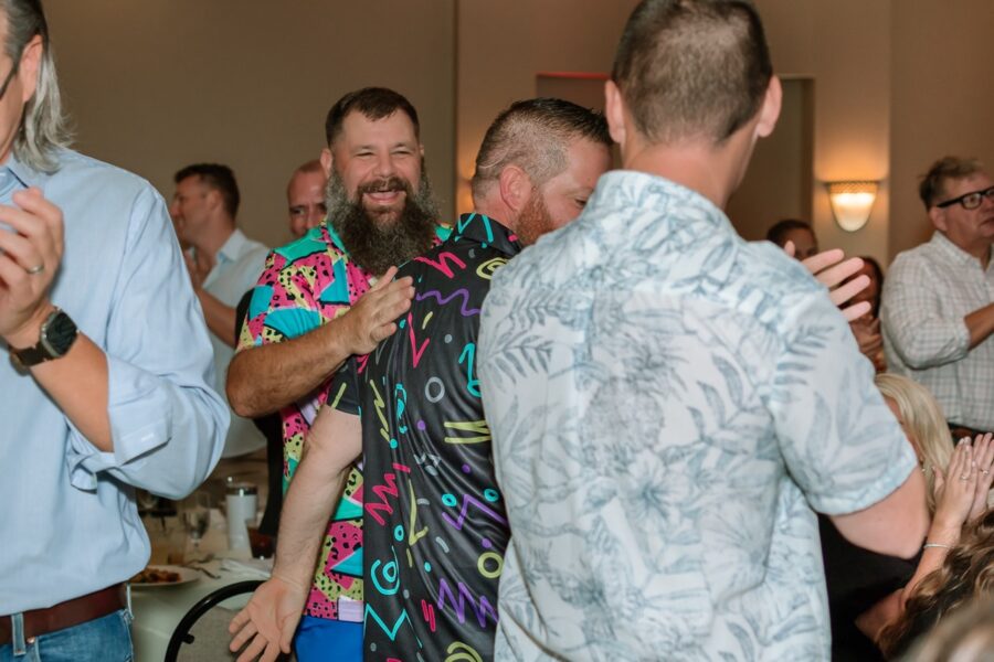 a group of men standing around each other