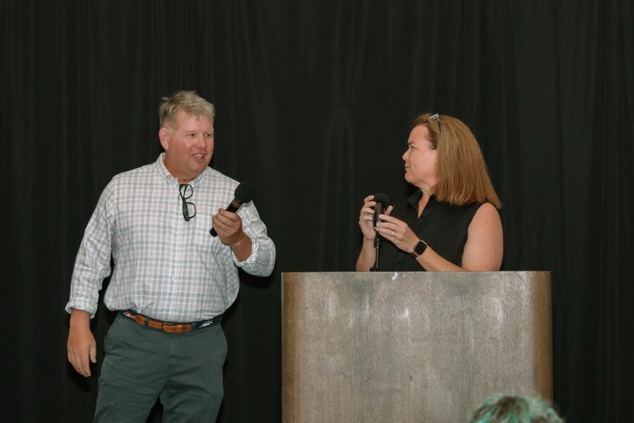 a man and a woman standing in front of a podium