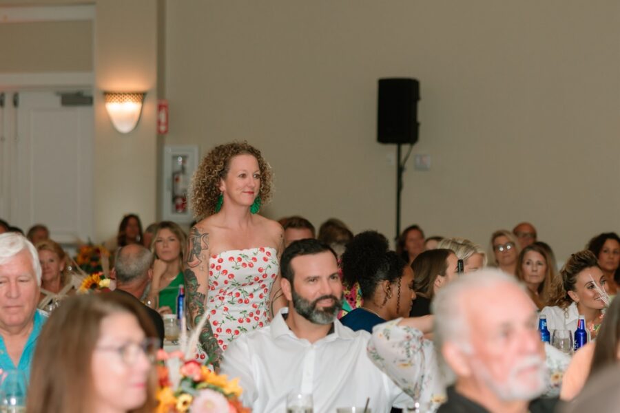 a woman walking down the aisle of a wedding