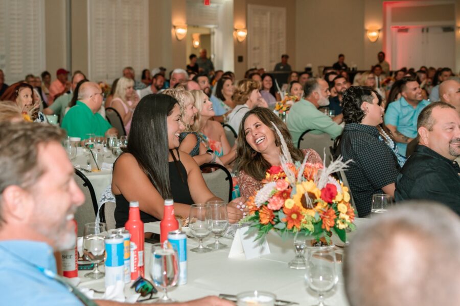 a large group of people sitting at tables in a room