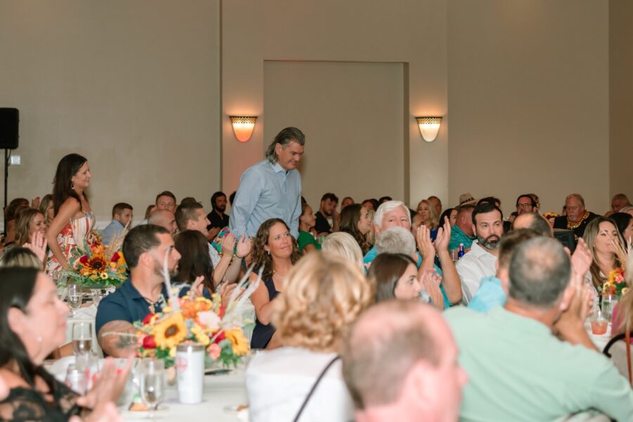 a large group of people sitting at tables in a room