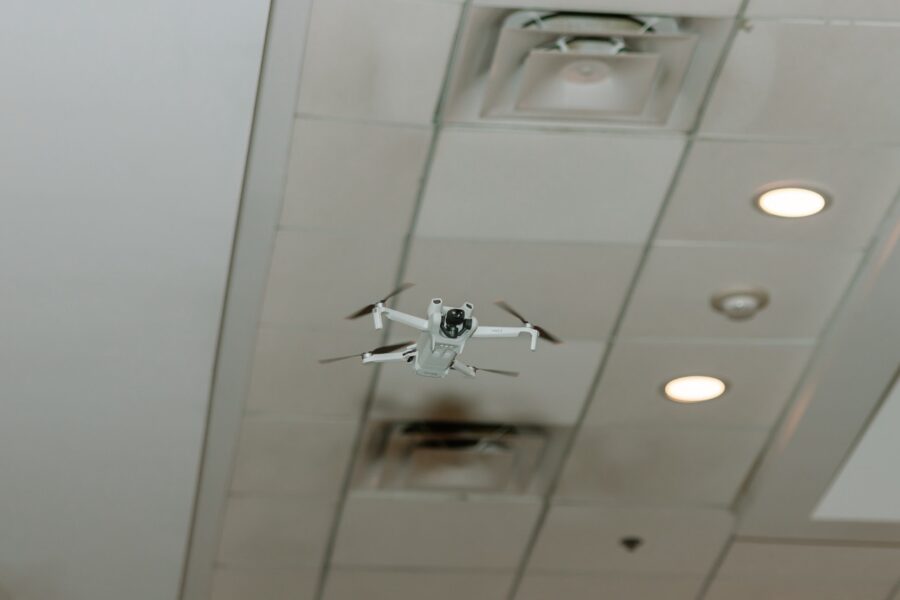 a small white airplane flying through a ceiling