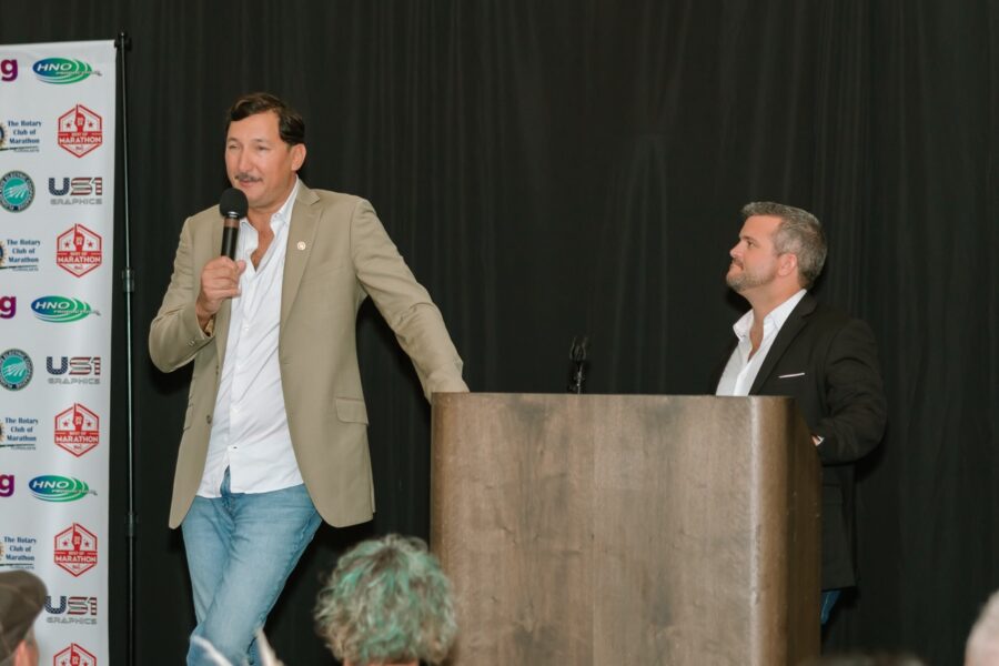 a man standing at a podium with a microphone