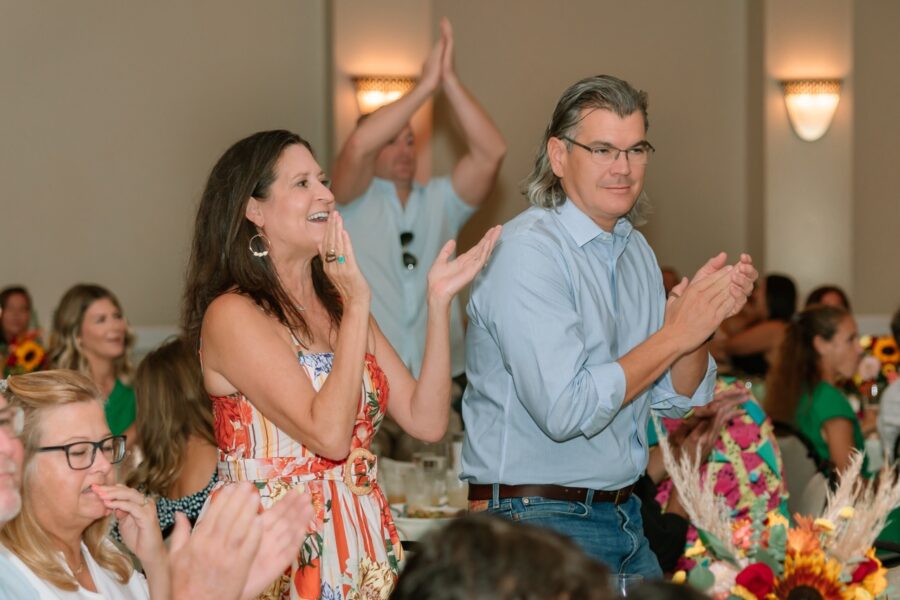 a group of people clapping at a party