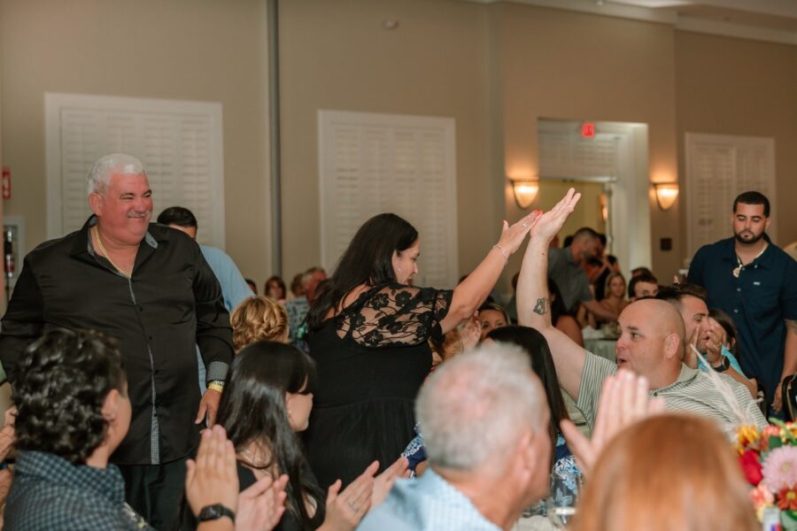 a group of people standing around each other at a party