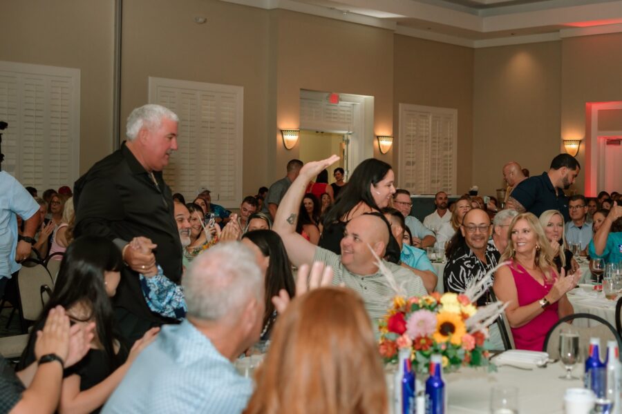 a large group of people sitting at tables in a room