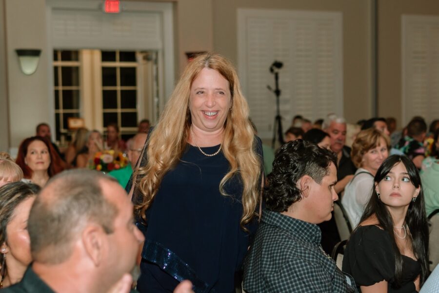 a woman standing in front of a crowd of people