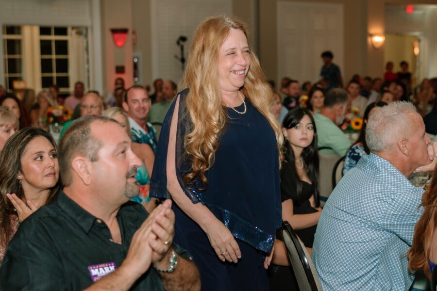 a woman standing in front of a crowd of people