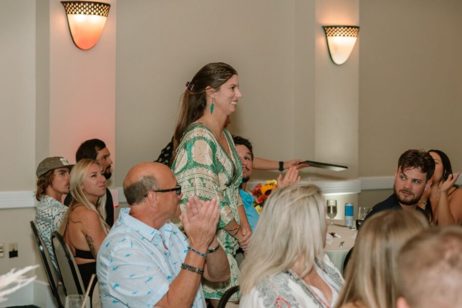 a woman standing in front of a crowd of people