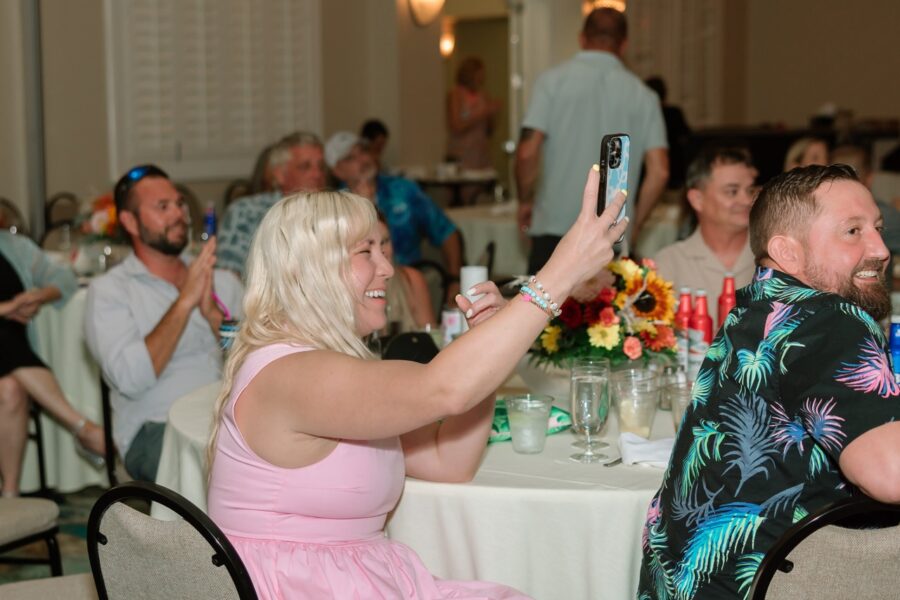 a man taking a picture of a woman in a pink dress