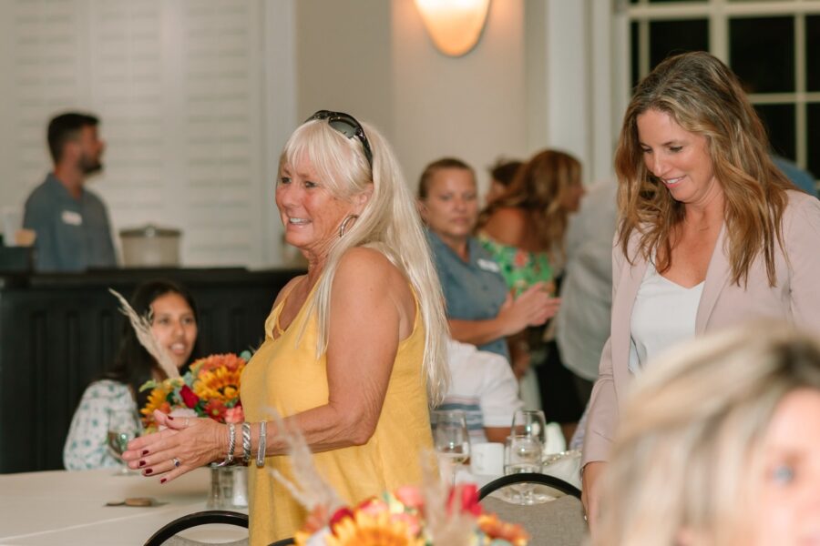 a group of women standing around a table