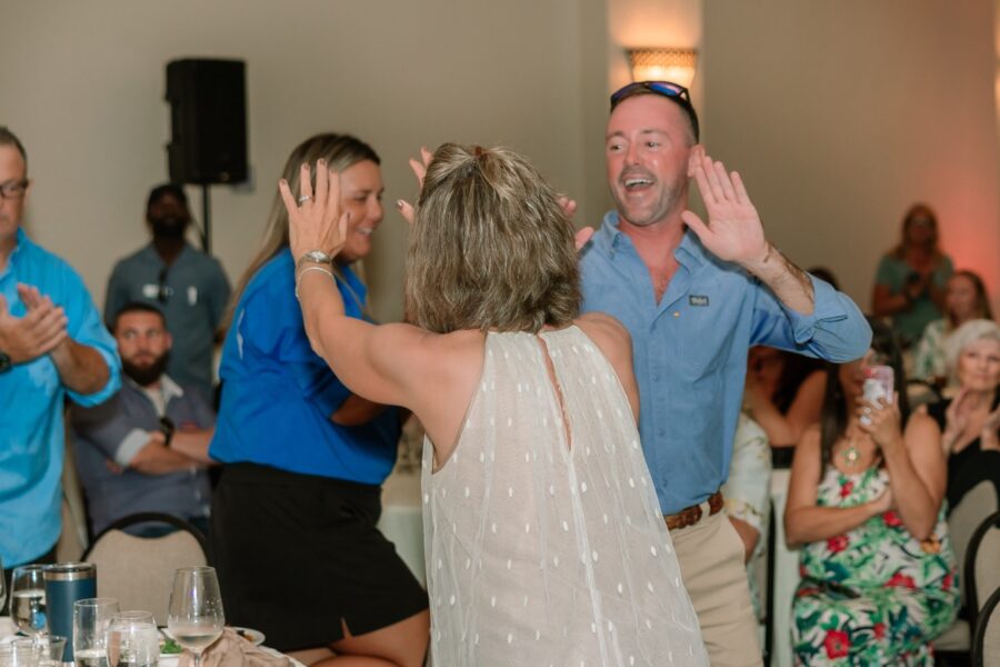 a group of people standing around a table