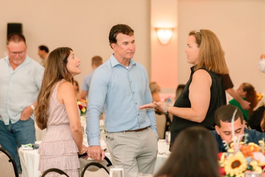 a group of people standing around a table