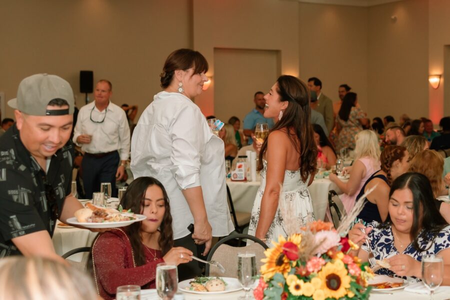 a group of people sitting at tables eating food