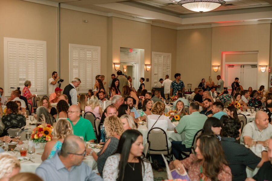 a large group of people sitting at tables in a room