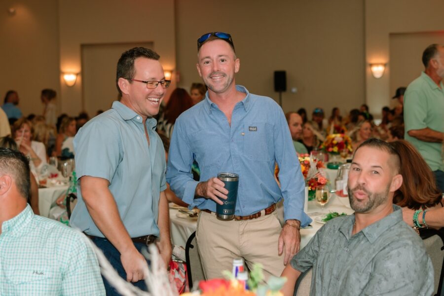 a group of men standing next to each other at a table