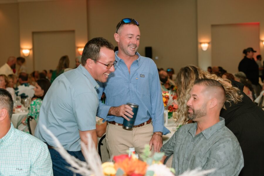 a group of men standing around a table