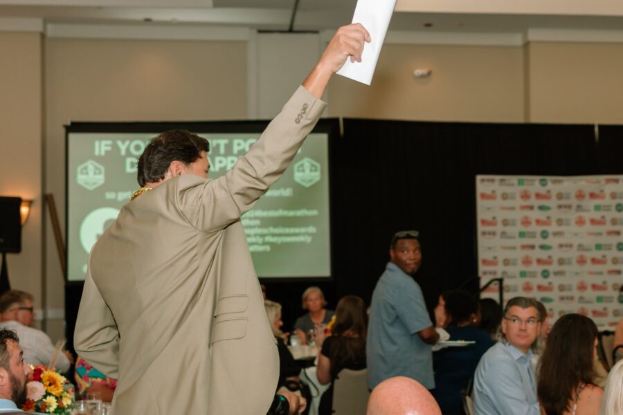 a man holding up a piece of paper in the air