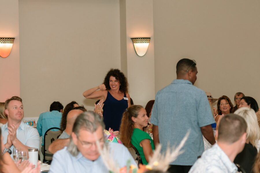 a group of people sitting at tables in a room