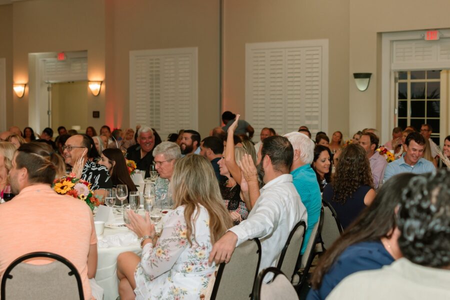 a large group of people sitting around a table