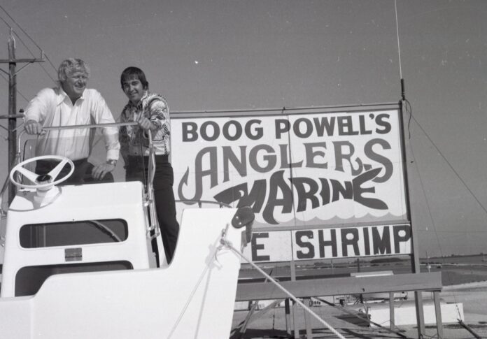 a couple of people standing on top of a boat